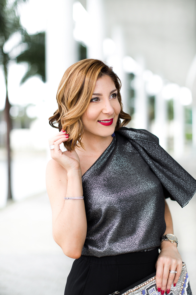 Blame-it-on-Mei-Miami-Fashion-Blogger-2016-Holiday-Outfit-NYE-Look-Metallic-Asymetric-Top-with-Ruffle-Joggers-Patent-Iriza-Louboutin-Beaded-Clutch-Tassel-Earrings-Curls-Short-Hair
